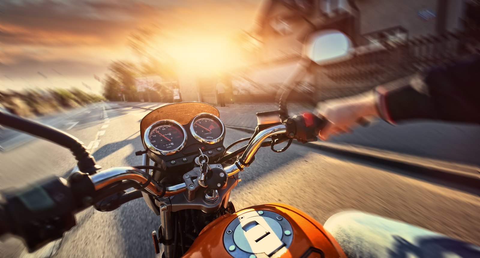 Motorcyclist drives motorbike on a sunny day on the street